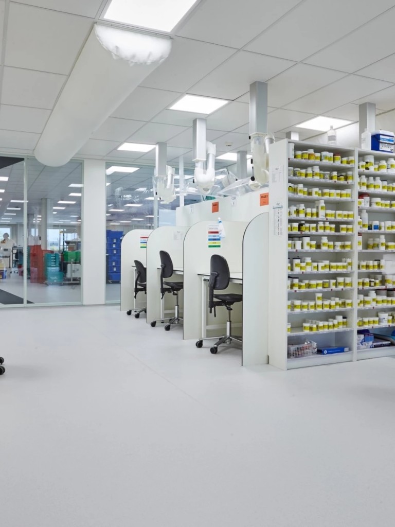 Schone productieruimte met medewerkers, machines en rekken met materialen