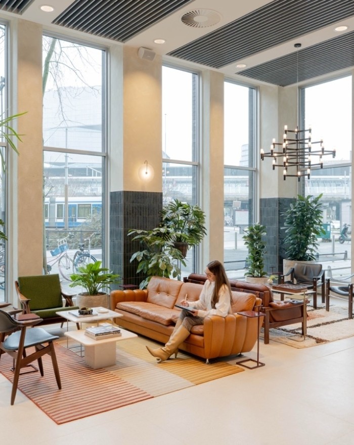 Modern office space with conference table, chairs and plants in an open workspace
