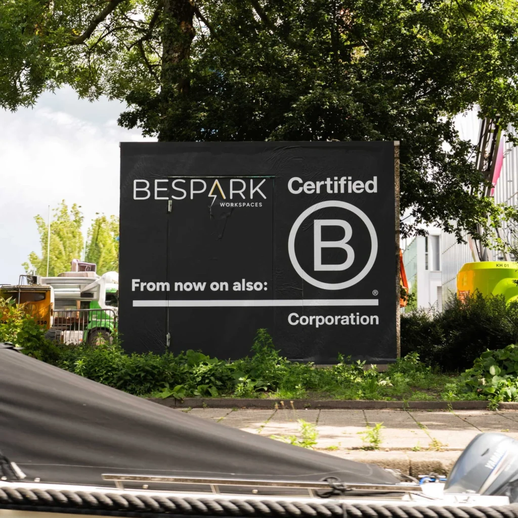 Reclamebord van Bespark Workspaces met aankondiging van hun B Corporation certificering.